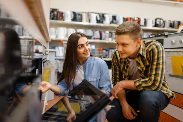 Couple choosing electric oven in electronics store
