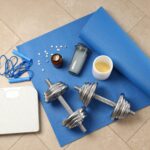 Fitness or sport accessories on fitness mat on floor