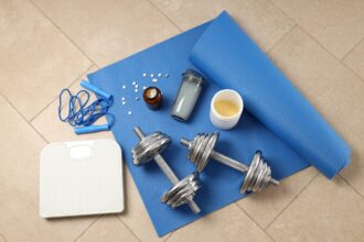 Fitness or sport accessories on fitness mat on floor