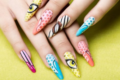 Long beautiful manicure in pop-art style on female fingers. Nails design. Close-up